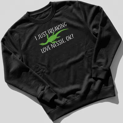 Cartoon Loch Ness Monster with humorous text about loving Nessie — printed on a unisex sweatshirt