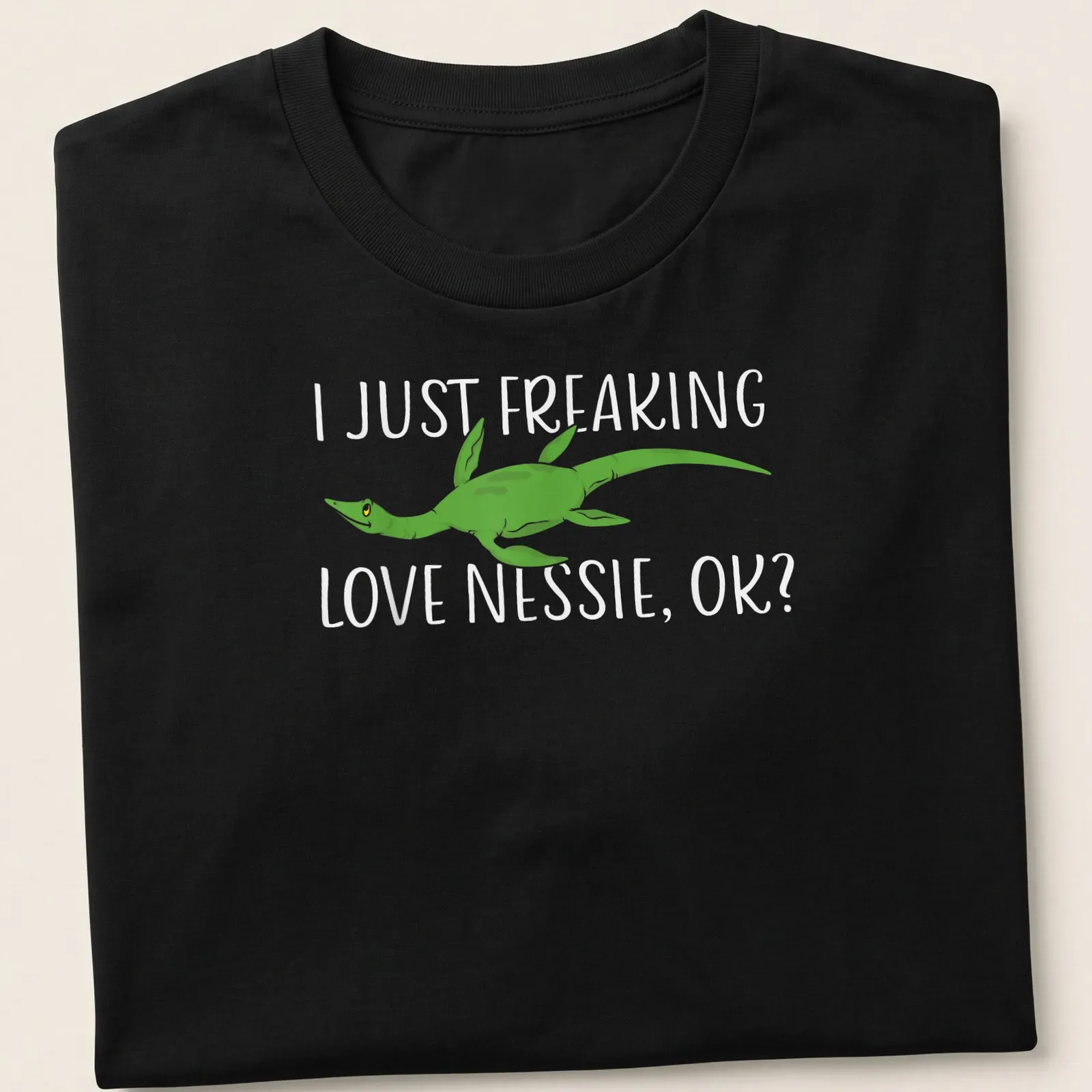 Cartoon Loch Ness Monster with humorous text about loving Nessie — printed on a unisex t-shirt