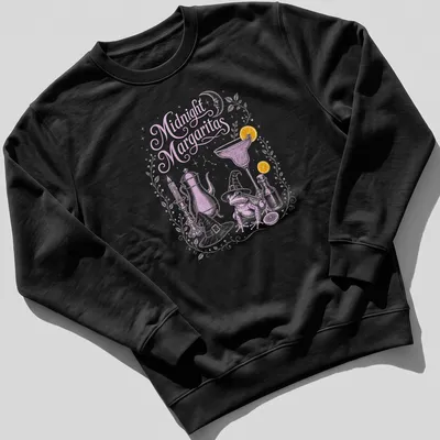 Whimsical illustration of a frog in a witch hat holding a margarita with candles around it — printed on a unisex sweatshirt
