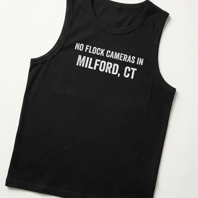 Bold text graphic stating No Flock Cameras in Milford, CT on a grey background — printed on a tank top