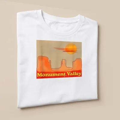 Watercolor print of Monument Valley with sunset colors of orange, yellow, red, and beige — printed on a unisex t-shirt (angled view)
