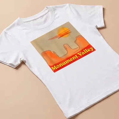 Watercolor print of Monument Valley with sunset colors of orange, yellow, red, and beige — printed on a women's shirt