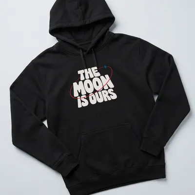 Bold typography T-shirt featuring the phrase 'THE MOON IS OURS' alongside a moon graphic — printed on a unisex hoodie
