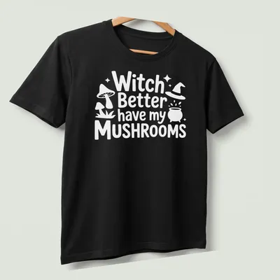 Whimsical illustration of a mushroom witch with playful text about mushrooms — printed on a unisex t-shirt (angled view)