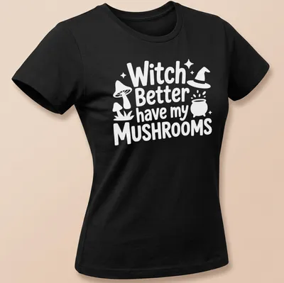 Whimsical illustration of a mushroom witch with playful text about mushrooms — printed on a women's shirt