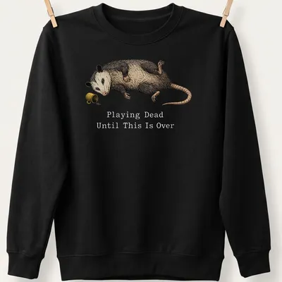 Realistic illustration of an opossum playing dead with humorous text — printed on a unisex sweatshirt