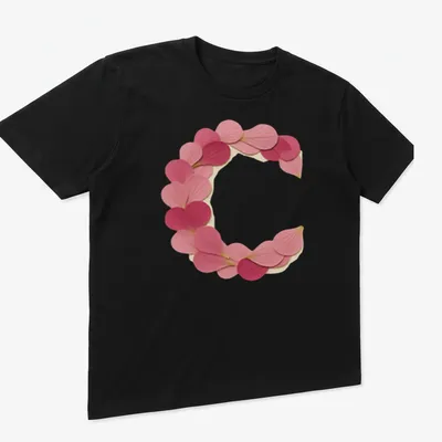 Vintage style t-shirt featuring a letter C formed from pink petals — printed on a unisex t-shirt (angled view)