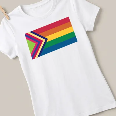 Vibrant Pride flag with an arrow design in rainbow colors — printed on a women's shirt