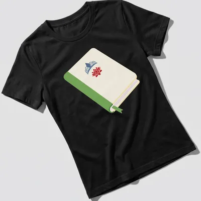 Illustrated t-shirt featuring a princess book with a lotus flower and crown in cream, green, red, and blue. — printed on a women's shirt