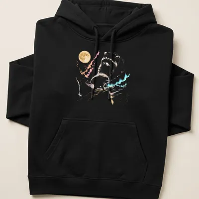 Watercolor design featuring a playful raccoon under a moonlit sky with vibrant colors — printed on a unisex hoodie
