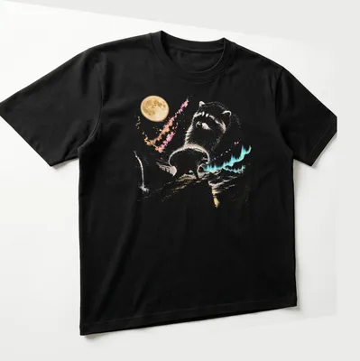 Watercolor design featuring a playful raccoon under a moonlit sky with vibrant colors — printed on a unisex t-shirt (angled view)