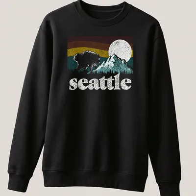 Retro bear graphic with Seattle text in pink, blue, yellow, and green — printed on a unisex sweatshirt