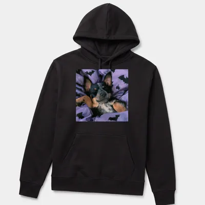 Realistic depiction of a sleepy Cattle Dog on a purple bat-patterned blanket — printed on a unisex hoodie