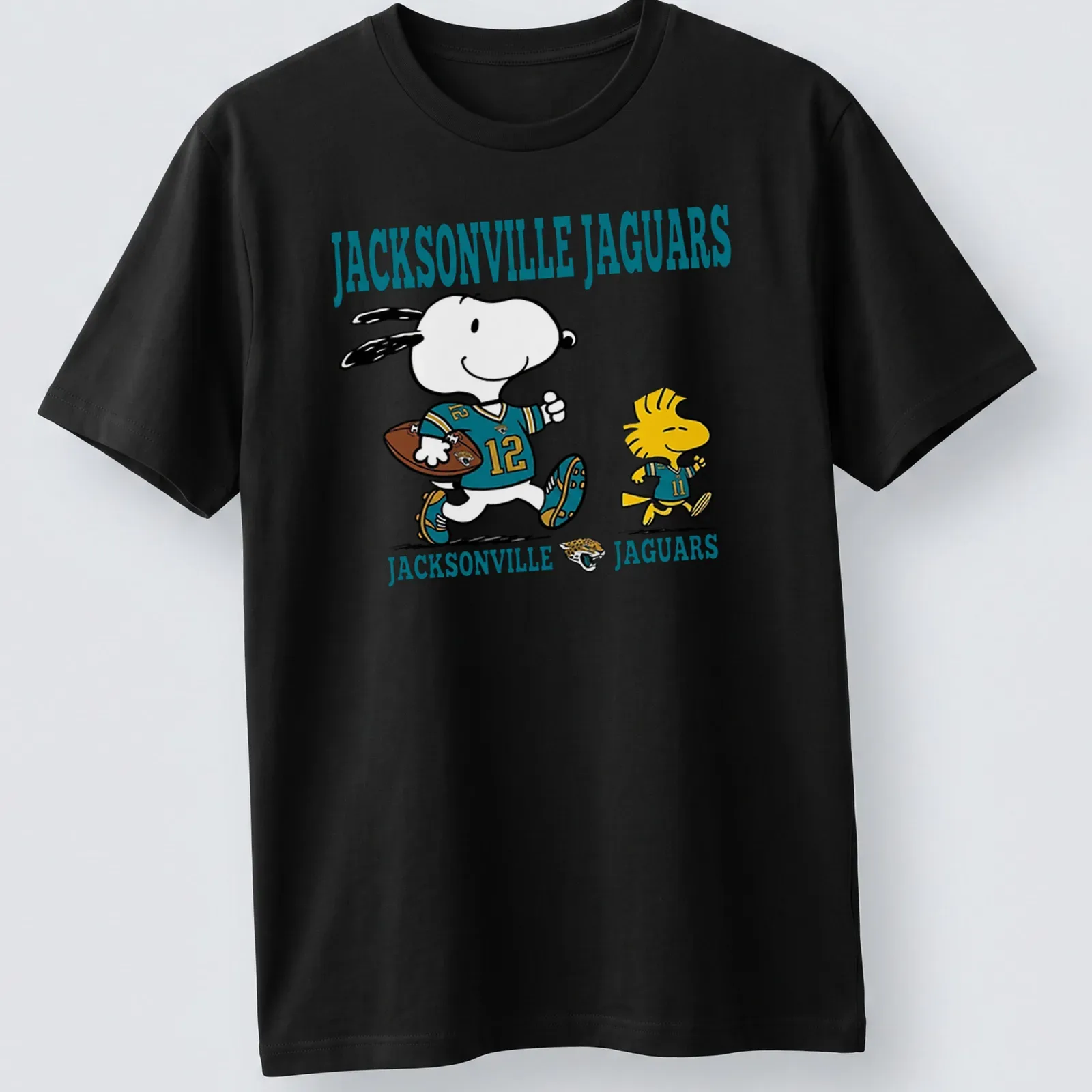 Cartoon Snoopy and Woodstock supporting the Jacksonville Jaguars in teal and black — printed on a unisex t-shirt