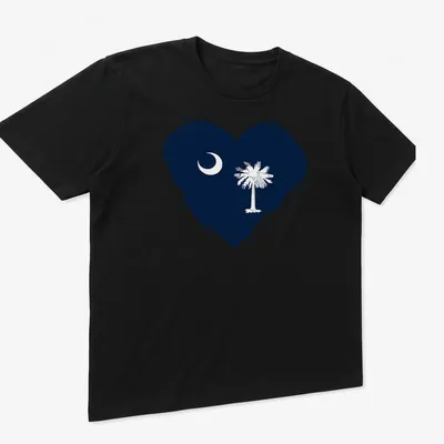 Distressed graphic of South Carolina flag heart featuring crescent moon and palm tree — printed on a unisex t-shirt (angled view)