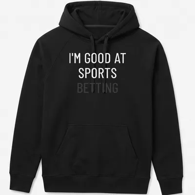 Bold typography t-shirt saying 'I'm Good At Sports Betting' in black on white. — printed on a unisex hoodie