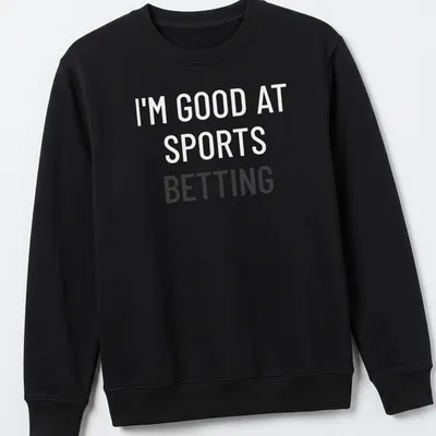 Bold typography t-shirt saying 'I'm Good At Sports Betting' in black on white. — printed on a unisex sweatshirt