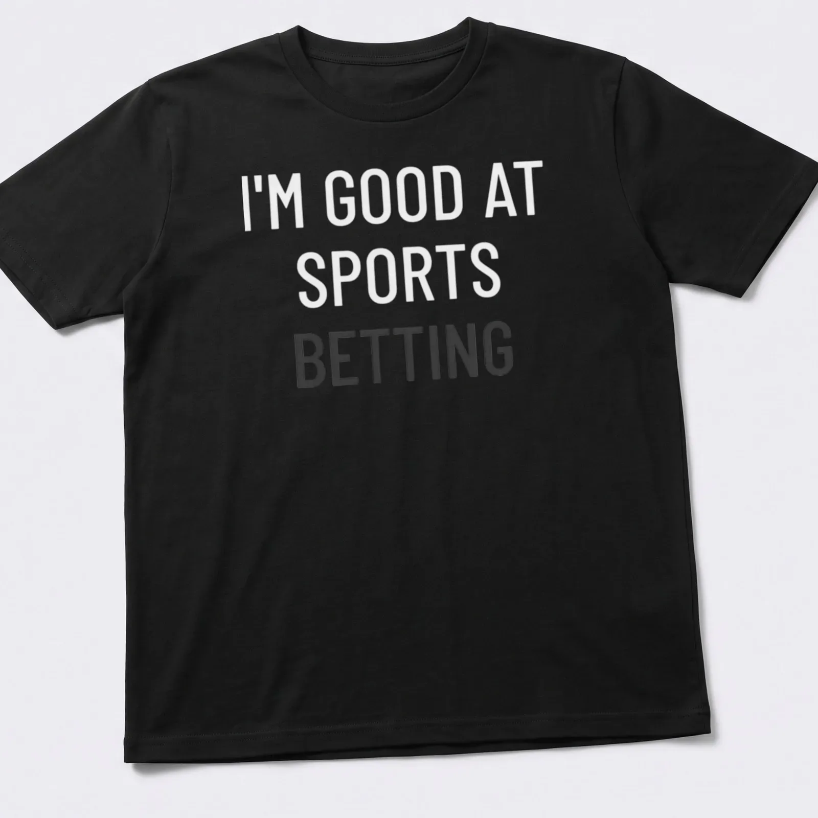Bold typography t-shirt saying 'I'm Good At Sports Betting' in black on white. — printed on a unisex t-shirt