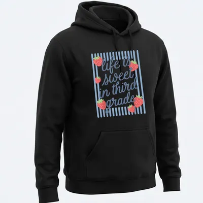 Playful illustration of a strawberry with text 'life is sweet in third grade' — printed on a unisex hoodie
