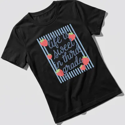 Playful illustration of a strawberry with text 'life is sweet in third grade' — printed on a women's shirt
