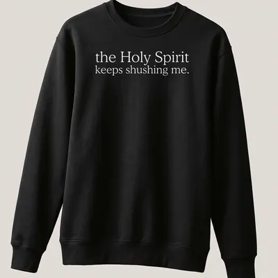 Simple white text reading 'the Holy Spirit keeps shushing me.' on a T-shirt. — printed on a unisex sweatshirt