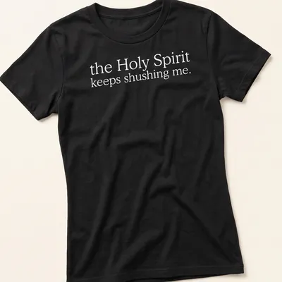 Simple white text reading 'the Holy Spirit keeps shushing me.' on a T-shirt. — printed on a women's shirt