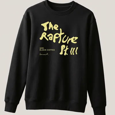 Playful black coffee-themed t-shirt with handwritten style text in yellow and white — printed on a unisex sweatshirt