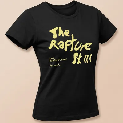 Playful black coffee-themed t-shirt with handwritten style text in yellow and white — printed on a women's shirt