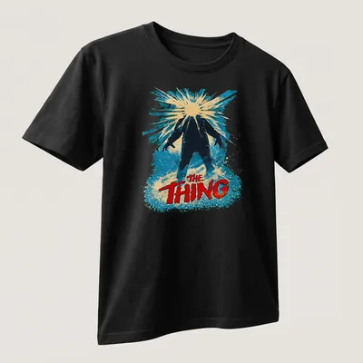 Retro design featuring The Thing title in bold colors and style — printed on a unisex t-shirt (angled view)