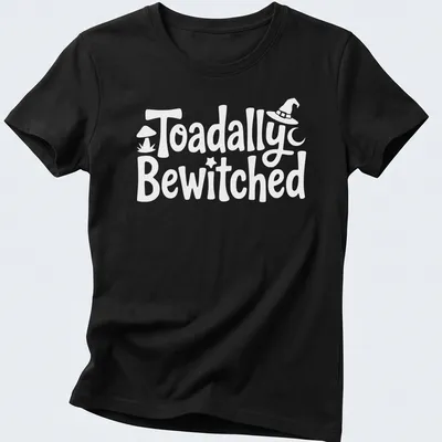 Cartoon toad graphic with playful text 'Toadally Bewitched' in green and black. — printed on a women's shirt