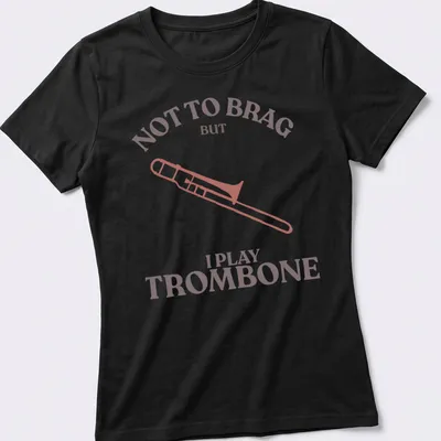 Illustration of a trombone with text: Not to Brag But I Play Trombone in pink, brown, and white — printed on a women's shirt