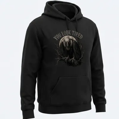 Retro vulture illustration with the text 'YOU LOOK TIRED' in black, gray, and white. — printed on a unisex hoodie