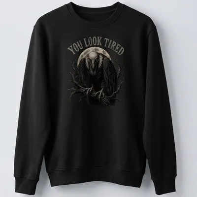 Retro vulture illustration with the text 'YOU LOOK TIRED' in black, gray, and white. — printed on a unisex sweatshirt