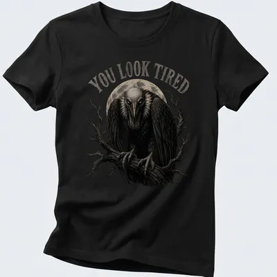 Retro vulture illustration with the text 'YOU LOOK TIRED' in black, gray, and white. — printed on a women's shirt
