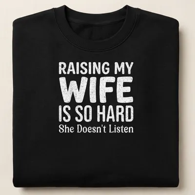 Bold playful typography on a light gray shirt about raising a wife. — printed on a unisex sweatshirt